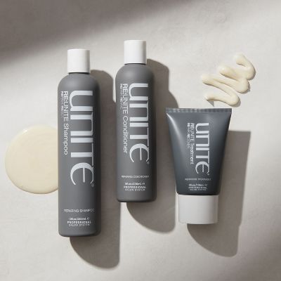 UNITE shampoo and conditioner bottles with creamy product swatches on neutral background.