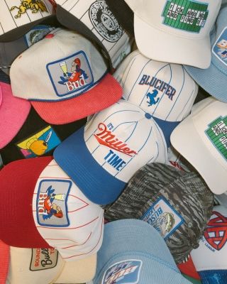 Bright pink corduroy trucker hat with Big League Chew embroidered patch displayed on wooden shelf