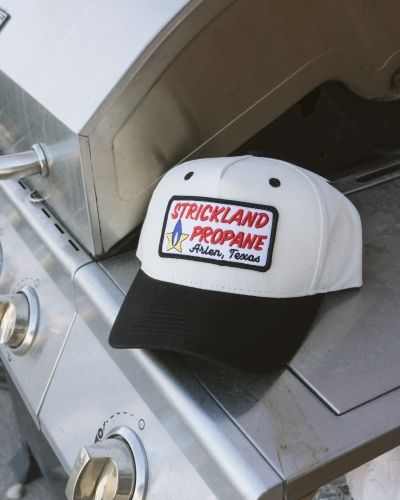 Vintage-inspired snapback hats with colorful embroidered logo patches and corduroy brims from SNAG Collective