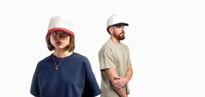 Male and female models wearing minimalist two-tone baseball caps
